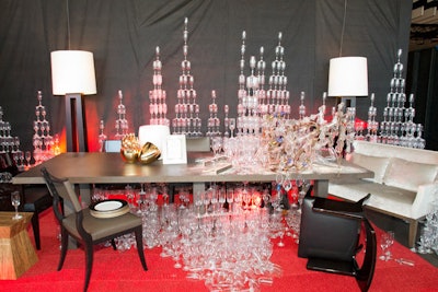 Designer Douglas Little partnered with Liaigre to create The New York Times’ irreverent table, which Little described as “a dinner party gone mad.” Towering skyscrapers of champagne flutes lined the space, while a crashing chandelier took center stage.