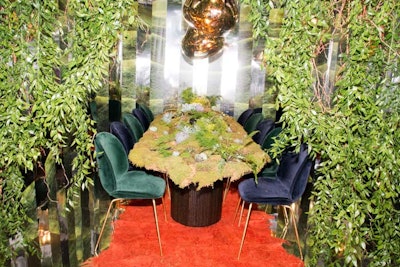 Design firm Language Dept. built a lush garden setting for Design Within Reach, complete with a moss-covered tabletop and hanging vines; mirrored walls and place settings offered a manmade contrast to the natural habitat.