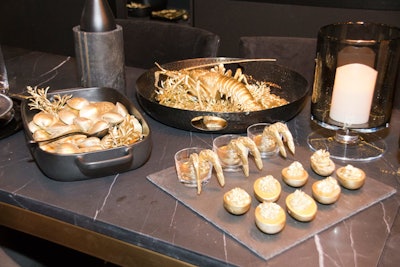 Crate and Barrel's dark kitchen design served gold-painted “midnight snacks.”