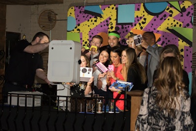 Staffers posed for photos in front of an '80s-theme backdrop.