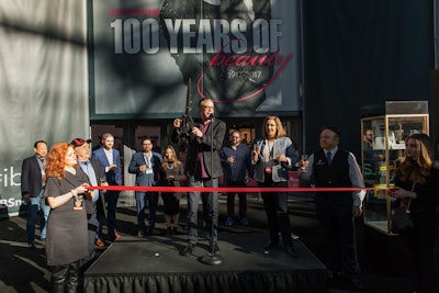 Gordon Miller, publisher of American Salon magazine, which is owned by show producer Questex, led the ribbon-cutting ceremony to mark the 100th anniversary and open the show Sunday morning.