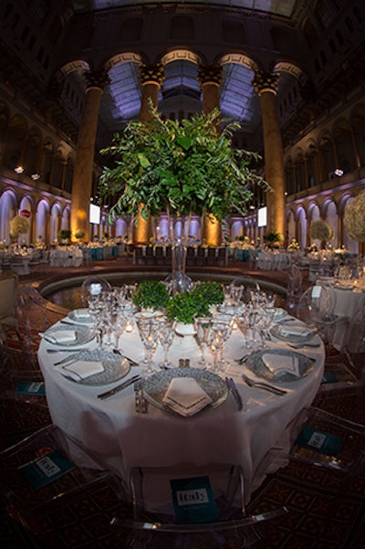 Tutera created four tabletop designs mixing white and blue linens, silver place settings, and four styles of chairs. The centerpieces included Italian ruscus, Italian lemon leaf, and Italian olive leaf as well as boxwoods and baby's breath, the latter of which was inspired by the clouds in paintings by Michelangelo.