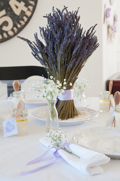 At a purple-theme baby shower created by Frog Prince Paperie, centerpieces comprised abundant bundles of lavender atop lace handkerchiefs.