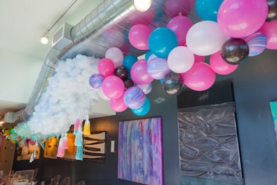 The brunch featured a 25-foot ceiling installation designed by Taylor and Hov's creative director and executed by Garette Turner of Brightly Ever After. The colorful focal point featured marble balloons and oversize cotton clouds.