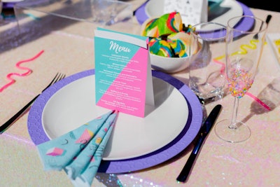 The brunch menu, provided by Relish Catering, included rainbow bagels, smoked salmon, avocado toast, and egg bake. Menus and printed cloth napkins had a blue and pink color scheme.