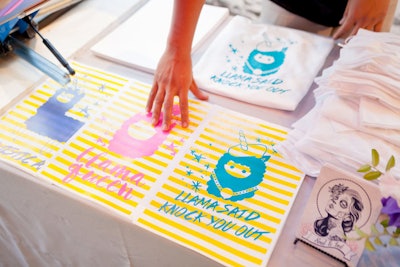 Soul & Ink's live screen-printing station offered prints and T-shirts that were custom-designed by Taylor and Hov.