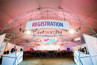 Guests registered under a dome structure in the main tent, an airy space filled with lounge seating.