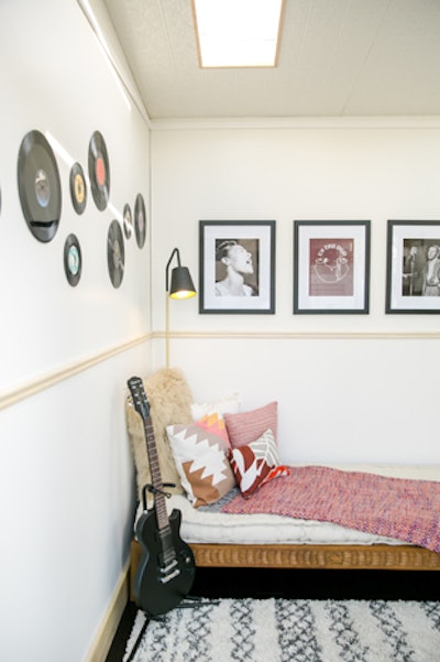 Inside the home inspired by Us the Duo, decor included records, a guitar, and portraits of musicians.