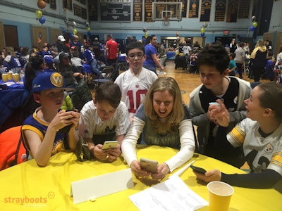 Solving trivia challenges in a school team building activity.