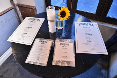 The pop-up included branded white candles and sunflowers as centerpieces, with on-theme menus that included Tupac-inspired cocktails and images of the rapper.
