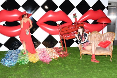 Oversize red inflatable lips decked a surrealist wall, above a rainbow of color-blocked candy.