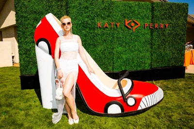 At the Katy Perry Footwear Easter Sunday Recovery Brunch, produced by the H.Wood Group, a giant three-dimensional shoe stood in front of a hedge wall bearing the brand's logo.