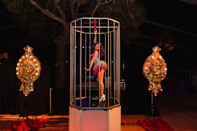 Golden, LED-decorated jester faces provided accent decor for bar areas and dancer platforms, which were enclosed in caging.