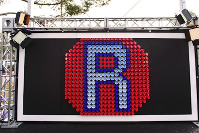 Using red and blue Solo cups, Elite Productions designed a custom art installation and media wall, bearing an 'R' for Roth.