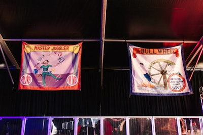 Vintage circus-character banners, featuring characters such as the 'Master Juggler,' decorated the space.