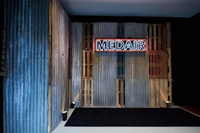 The Medair New York gala in March included famous street artists such as Shepard Fairey, as well as well-known subway performers, as part of an overall urban vibe at the fund-raiser. HL Group produced, and Raven Hollow Guild created a neon sign atop corrugated metals as part of the decor.