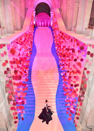 Ávila flanked the Great Hall stairs with towering mirrored walls (perfect for selfies) that, when combined with the ceiling lit in hot pink, created a setting that enticed many a guest—including Celine Dion (pictured)—to strike their best pose.