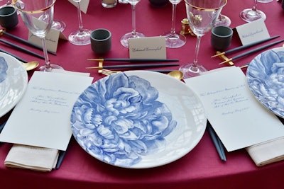 Tables were set with plates printed in a blue peony pattern. Chopsticks were provided in a nod to Kawakubo's Japanese descent, as was the Kikusui Junmai Ginjo sake and matcha, coconut mango, and yuzu citrus mochi served for dessert.