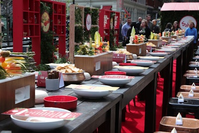 A 44-foot wooden table featured crudité centerpieces, bowls of pretzel sticks and pita chips for dipping, custom menus, and personal bowls in which diners could place hummus and other food that was offered.