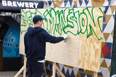 The outdoor area featured cans of beers, live music, retro boom boxes, and live graffiti art.