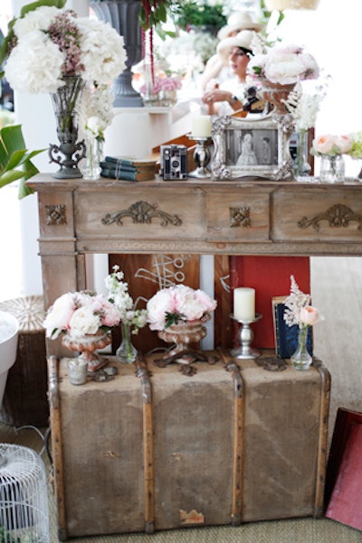 Props including framed photos, old books, candles, and antique luggage were used to create an inviting atmosphere.