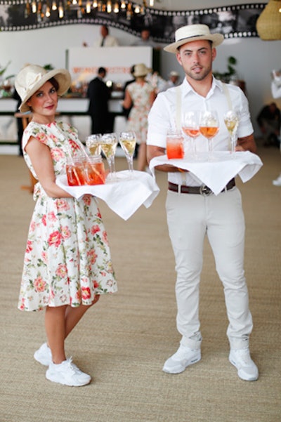 Servers dressed the part of the 1920s, with women wearing floral dresses, pearls, and gloves; men sported suspenders and hats.