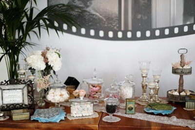 An elegant candy bar was displayed atop lace table runners.