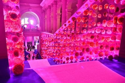 The stenciled sisal from the red carpet extended into the building from the steps outside, through the Great Hall, and up the Great Hall stairs, which were covered in hundreds of hand-strung balls made of pink and hot-pink or burgundy roses.