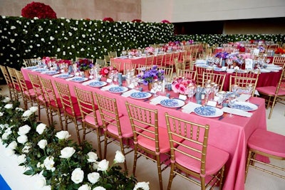 Once in the dinner space, a much more subdued wall of white roses and white rose hedges surrounded guests. Gold ballroom chairs boasted cushions that matched the tablecloths.