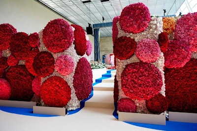 Guests entered the Temple of Dendur for dinner, walking between two walls of off-white flowers covered in 3-D dots made from hot-pink and burgundy roses. A trompe l'oeil royal-blue muslin curtain, highlighted in gold, draped the stage where a performance by Katy Perry would later take place.