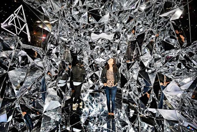 The audiovisual tunnel was created with reflective geometric panels and six of Sony's A1E Bravia OLED televisions, which broadcasted images including 3-D triangles that resembled the installation's design.