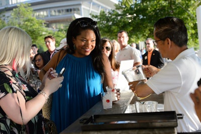 After leaving the opening reception, guests walked down the boardwalk where they stopped at three bars, each one serving a different element of a Black Eyed Susan cocktail, a traditional Maryland drink, beginning with ice, followed by a choice of pineapple or orange juice, and finishing with the liquor.