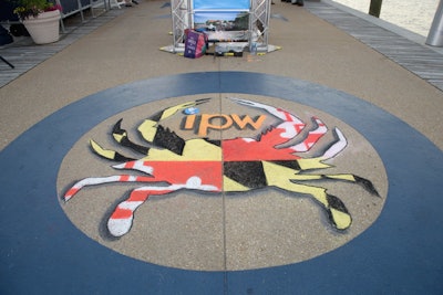 An artist drew a chalk drawing live, which guests photographed throughout its creation, incorporating the Maryland flag and IPW logo on the walkway of the east pier during the second portion of the three-venue event.