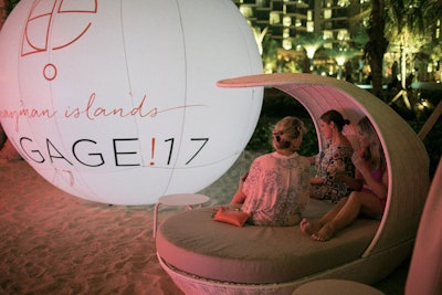 Guests gathered for the beach party on the first day of the conference. Illuminated signage contrasted with the natural setting.