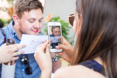 In another activity, people applied lipstick and kissed one of the Bethesda Row Fashion Carnival kiss cards twice, leaving behind their lip prints.