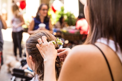 Hair braiding, done by UrbanStems, incorporated fresh flowers.