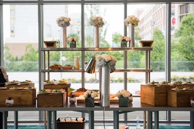 The catering display included natural wood boxes and florals to create an inviting array of foods.