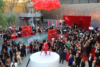 A balloon sculpture installation resembled red blood cells overhead, and aerialists performed throughout the red-dominated space.