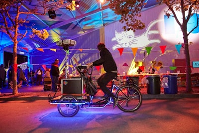 The large tents that housed sessions during the day became canvases for pop-up artwork during the opening night Block Party. Cyclists with projectors mounted on their bikes would stop to show a scene or short film on the side of the tent.