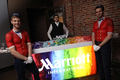 Marriott International got fully into the pride celebration with a rainbow-colored macaron bar and servers in painted bellhop uniforms wandering throughout the party, and often posing for photos, with the colorful desserts.