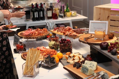 Eatertainment created a 15-foot long 'surf-and-turf' charcuterie station that featured prosciutto sliced to order, artisan cheeses, arctic char gravlax, tandoori shrimp, ceviche, and more.