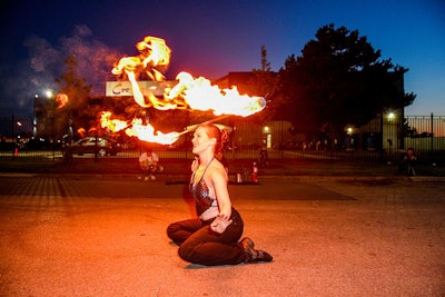 A fire performer known as Scarlet Black put on a show in front of the building. The entertainment was kept a secret, so Eatertainment faked a fire alarm to move attendees outside.