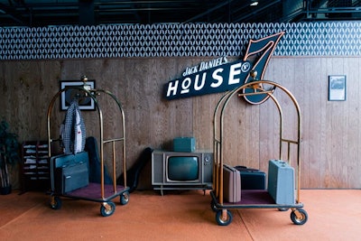 Similar to the New Orleans event, retro hotel-inspired decor elements like luggage carts and suitcases adorned the entryway.