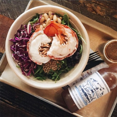 Seasonal Wild Blue Salad with a full chilled lobster tail, served on a bed of baby arugula, house-pickled wild Maine blueberries, shredded red cabbage, white beans, and a sprinkling of roasted sunflower seeds with a house-made balsamic vinaigrette, by Luke’s Lobster in New York