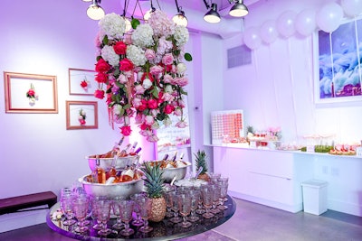Using roses, Bloom Plus created a chandelier, building a focal point for the room that sat above the wine selection.