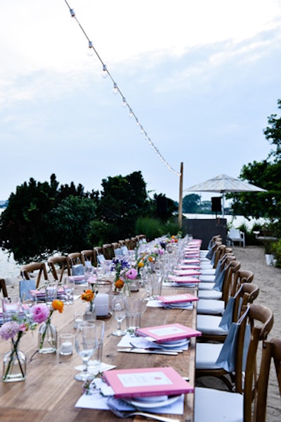 Floral arrangements with orange, pink, and purple blooms by the Popup Florist decorated the table.