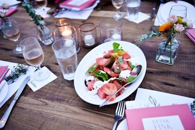 Chef Ari Taymor of Alma at the Standard, Hollywood prepared a three-course dinner, which included a tomato and watermelon salad with stracciatella and black garlic (pictured) and glazed smoked ribs with cornbread, green beans with hazelnuts, and carrot and cabbage slaw.
