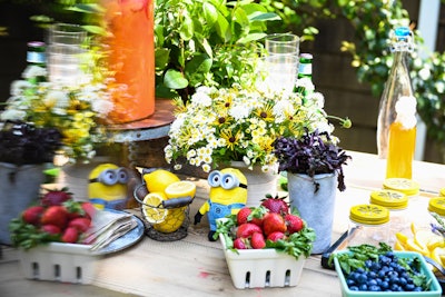 The tabletop decor was classic Hamptons farm stand: simple, colorful, and fresh. Fresh strawberries and blueberries were a nod to food and drink ingredients, while bouquets of daisies added a touch of relaxed elegance. Adorable Minion dolls were scattered throughout the tables, as well as lemon trees for a decidedly whimsical touch.