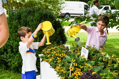 In the Minion garden, children could take turns watering the planted daisies using watering cans printed with branding from the event. In their gift bags, guests received a scaled-down watering can along with a matching gardening set and a Minion doll.