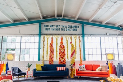 The stage backdrop featured oversize rope art similar to a summer camp craft.